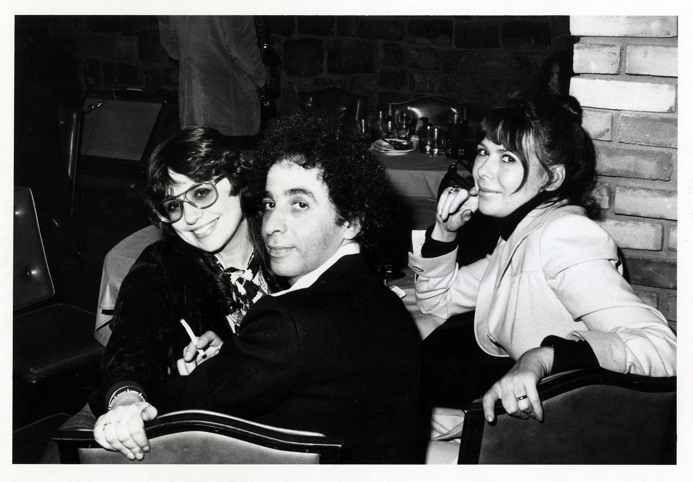 two women and one man in a restaurant